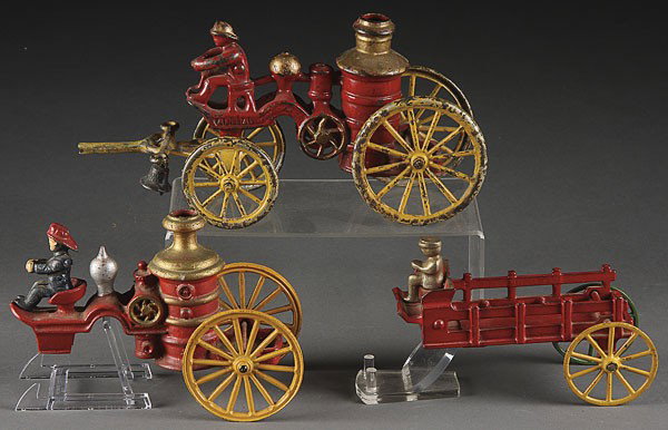 CAST IRON TOY HORSE DRAWN FIRE ENGINE BACK ENDS: THREE CAST IRON TOY HORSE DRAWN FIRE ENGINE BACK ENDS. Comprising an early 20th century pumper, a reproduction pumper, and an early stake wagon with replaced wheel. Some damage, length 11 inches and 6