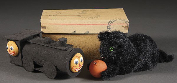 A VERY FINE EARLY GERMAN HALLOWEEN CANDY CONTAINER: A VERY FINE EARLY GERMAN HALLOWEEN CANDY CONTAINER AND KEY WIND CAT, EARLY 20TH CENTURY comprising a locomotive with jack-o-lantern's masks candy container, and a black cat with jack-o-lantern wind up
