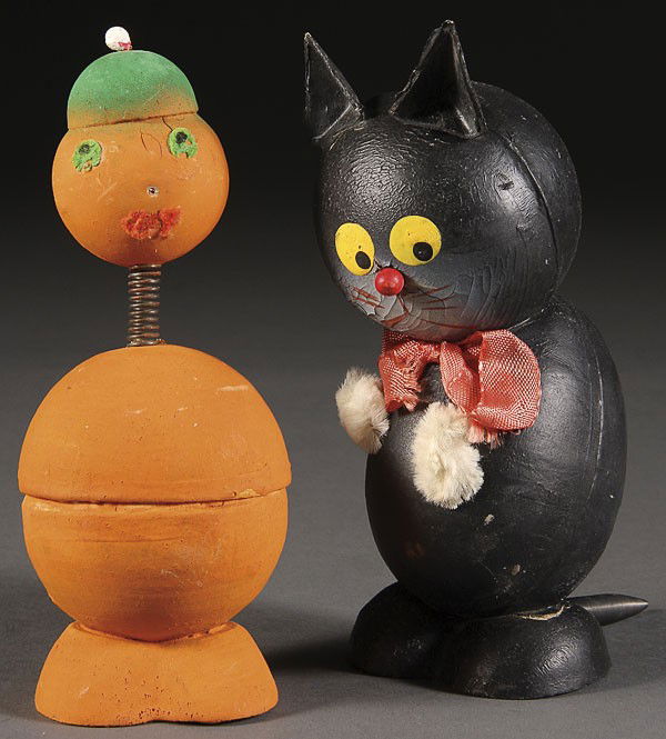 WESTERN GERMANY HALLOWEEN CANDY CONTAINERS: A PAIR OF WESTERN GERMANY HALLOWEEN CANDY CONTAINERS, MID 20TH CENTURY, comprising a black cat and a jack-o-lantern nodder, height 6 inches.