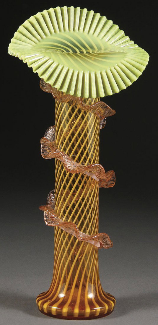 AN ENGLISH VICTORIAN JACK IN THE PULPIT ART GLASS: AN ENGLISH VICTORIAN JACK IN THE PULPIT ART GLASS VASE. Possibly by Stevens & Williams, in Amber glass internally decorated with opalescent spiral stripes below a green shaded and ruffled upturned fla