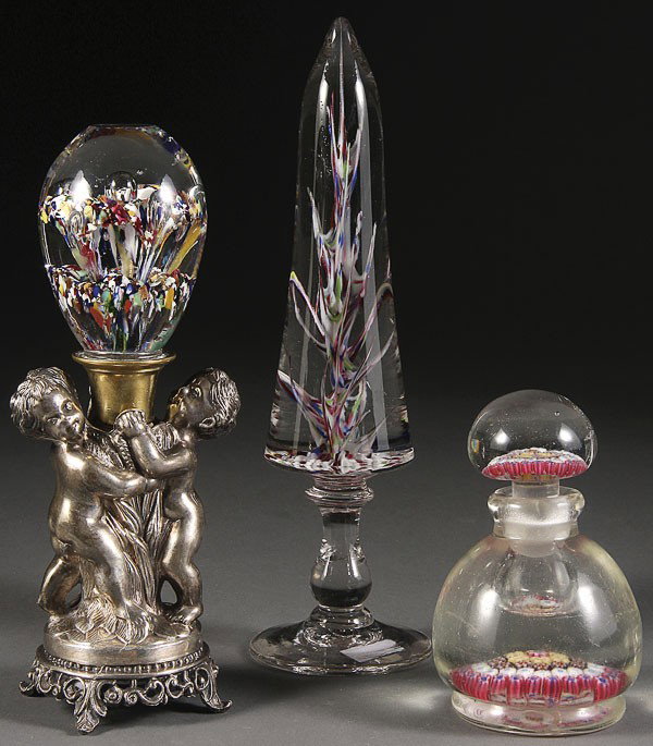 A VICTORIAN ART GLASS GROUP, 19TH CENTURY.: A VICTORIAN ART GLASS GROUP, 19TH CENTURY. Comprising a scramble flora form mounted on a double putto silvered figural base, a pedestal mounted mantle decoration of tapering cylindrical form and a mil
