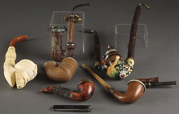 CARVED MEERSCHAUM AND PORCELAIN TOBACCO PIPES: A COLLECTION OF SIX CARVED MEERSCHAUM AND PORCELAIN TABACCO PIPES, 20TH CENTURY. Including a fine Turkish bust, a Bavarian man with bear keg, a silver mounted crest, a woven straw covered, and a gilt