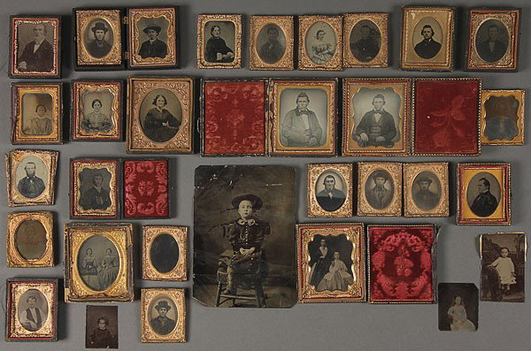 A GROUP OF 27 AMBROTYPE AND TINTYPE IMAGES: A GROUP OF 27 AMBROTYPE AND TINTYPE IMAGES, MID 20TH CENTURY. Comprising two fine 1/6th plate cased ambrotype portraits, each of a young gentleman and with hand tinted features, a 1/6th plate ambrotyp