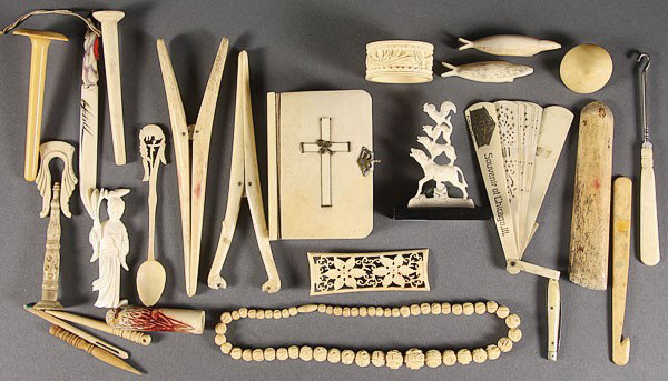 A FIGURAL BONE/IVORY GROUP, 20TH CENTURY.: A FIGURAL BONE/IVORY GROUP, 20TH CENTURY. 23 pieces including a figural seal, lohan, letter opener, necklace, knives, hair curlers, napkin ring, and other items. From 2 inches to 6.5 inches.