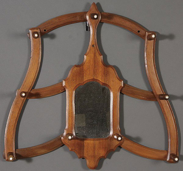A VICTORIAN FOLDING WALNUT MIRRORED HAT RACK: A VICTORIAN FOLDING WALNUT MIRRORED HAT RACK. With nine turned wood garment pegs mounted with porcelain buttons. Length 25 inches.