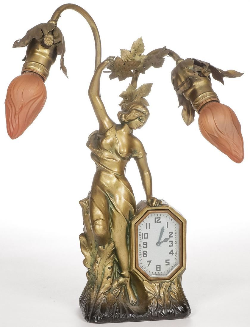 GOOD SCHADOW FIGURAL LAMP CLOCK: GOOD SCHADOW FIGURAL LAMP CLOCK. Takes a wind and runs and lights work. Height 15.4 inches. SHIPPING NOTICE: Jackson's is your sole and only source for one stop packing and shipping. With over 50 year