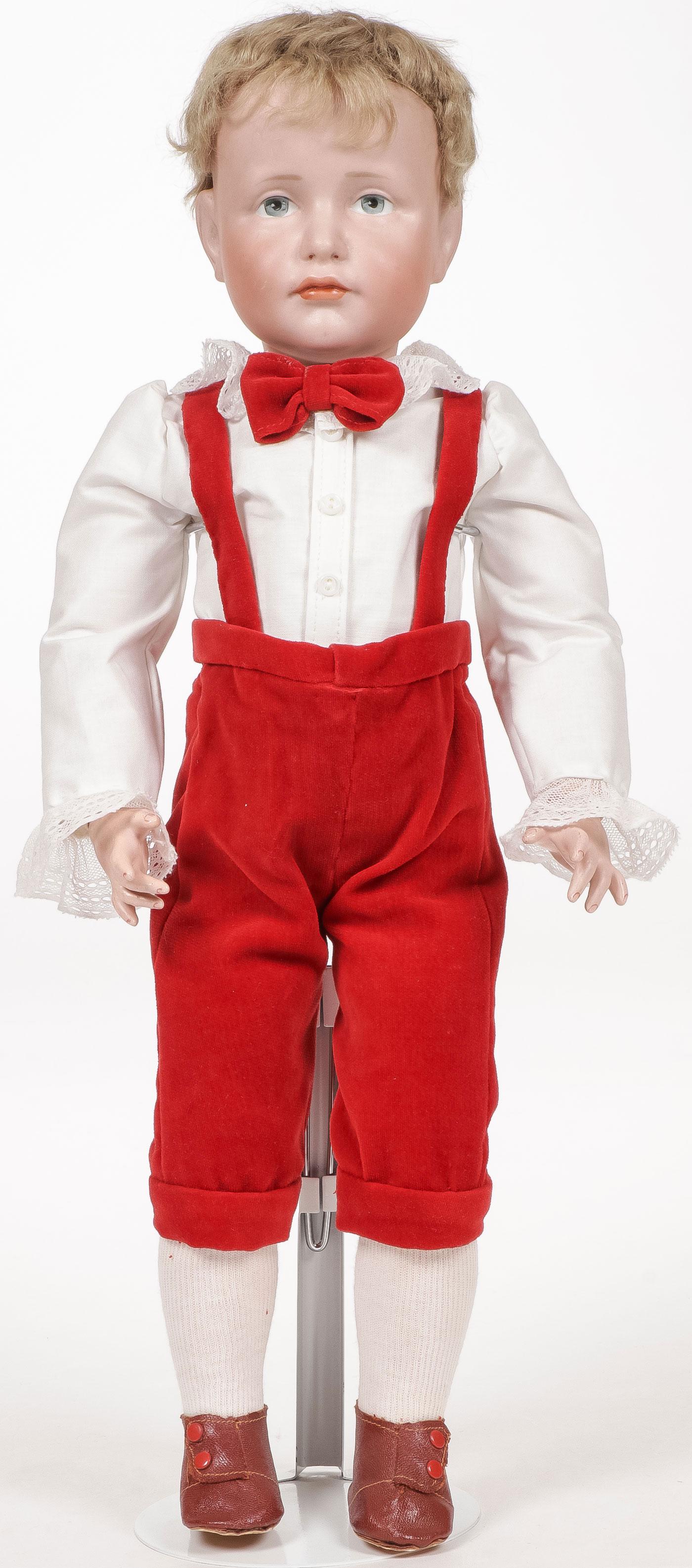 18 INCH KAMMER & REINHART NO. 114 CHARACTER DOLL: 18 INCH KAMMER & REINHART NO. 114 CHARACTER DOLL. The Hans doll with bisque socket head having painted blue eyes and closed pouty mouth, with original wig, exhibiting no cracks chips or hairlines, in