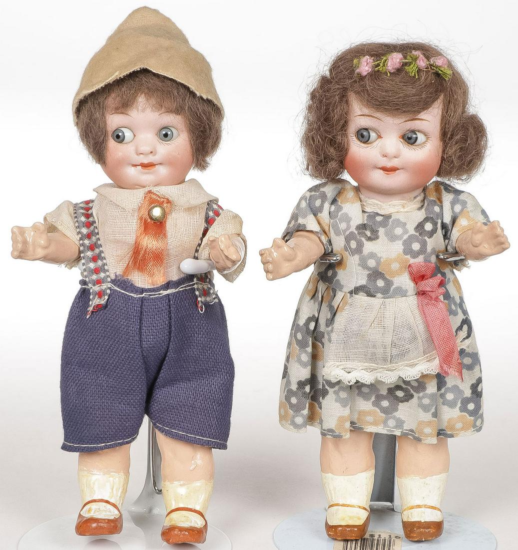 PR GERMAN BISQUE GOOGLY DOLLS: PR GERMAN BISQUE GOOGLY DOLLS. Comprising a boy and girl, both with five-piece chunky compo bodies, the boy marked A&M and the girl with indistinguishable mark. Both 7 inches in height.SHIPPING NOTICE