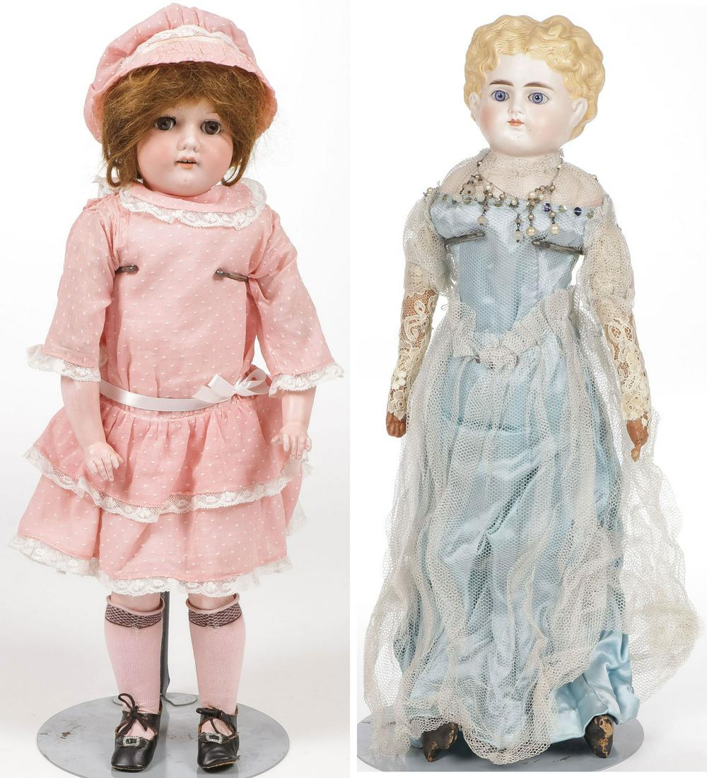 PAIR OF GERMAN BISQUE DOLLS.: PAIR OF GERMAN BISQUE DOLLS. . Comprising an A & M with sleep eyes, open mouth, in pink dress, and a bisque blonde-haired doll with glass eyes, repaired. Greatest height 19.5 inches.SHIPPING NOTICE:
