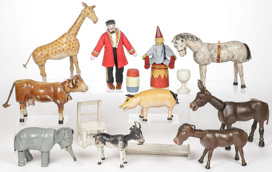 SCHOENHUT CIRCUS PIECES: SCHOENHUT CIRCUS PIECES. Comprising 15 individual pieces including a bisque headed animal trainer, a clown on drum, a pig, goat, horse, cow, giraffe, elephant, and other animals as shown, together wit