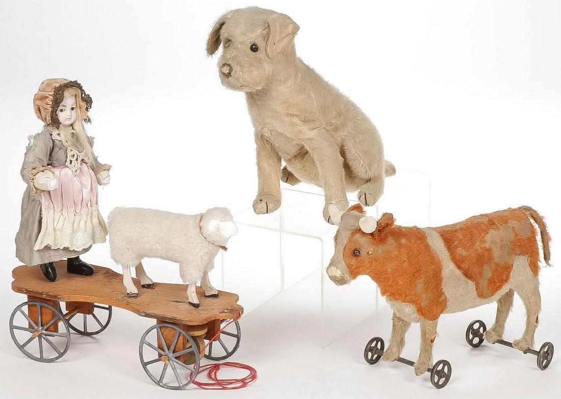 GERMAN PULL TOYS AND STEIFF: GERMAN PULL TOYS AND STEIFF. Comprising a charming Little Bo Peep pull toy, bisque head; a cow on cast iron wheels; and a Steiff seated dog. Greatest measurement 12 inches.SHIPPING NOTICE:Jackson's