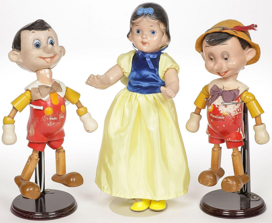 DISNEY IDEAL PINOCCHIOS AND SNOW WHITE: DISNEY IDEAL PINOCCHIOS AND SNOW WHITE. Comprising two wood, jointed and composition Pinocchios by Ideal as shown, and a Compo Snow White. Greatest height 13.7 inches. SHIPPING NOTICE: Jackson's is yo