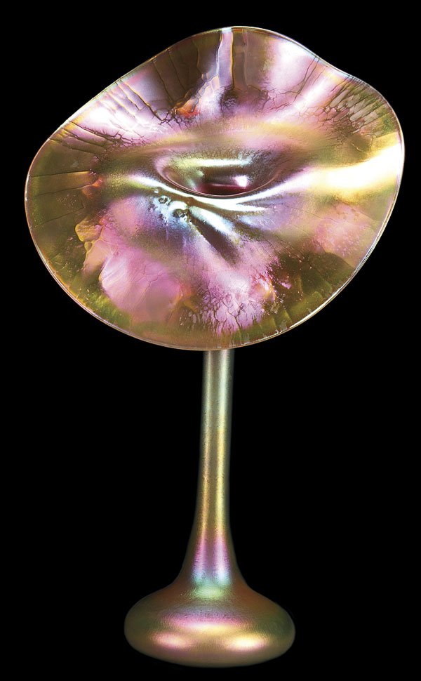 TIFFANY FAVRILE ART GLASS JACK-IN-THE-PULPIT VASE: A GOOD L.C. TIFFANY FAVRILE ART GLASS JACK-IN-THE PULPIT VASE, CIRCA 1902. In gold colored glass with elongated stem below a widely flared and upturned rim under an iridized shaded amethyst and bluish