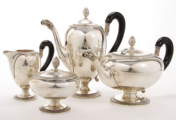 RUSSIAN STYLE SILVER 4 PIECE COFFEE/TEA SERVICE: A CONTINENTAL SILVER FOUR PIECE COFFEE/TEA SERVICE, 20TH CENTURY. Comprising a coffee pot, tea pot, lidded sugar and cream jug with leaf and dart embossed banded decoration, ebonized wood handles and 