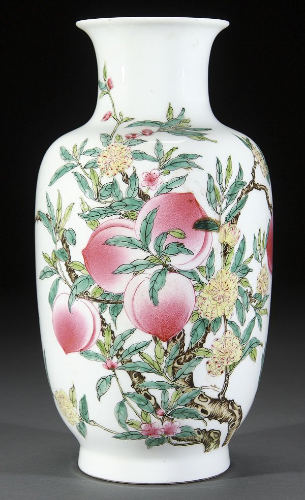 CHINESE FAMILLE ROSE VASE: A CHINESE FAMILLE ROSE "NINE PEACHES" PORCELAIN ROULEAU VASE. Finely painted with large peach blossoms and branches on a milky white ground, the base with blue underglaze Qianlong seal mark and old au