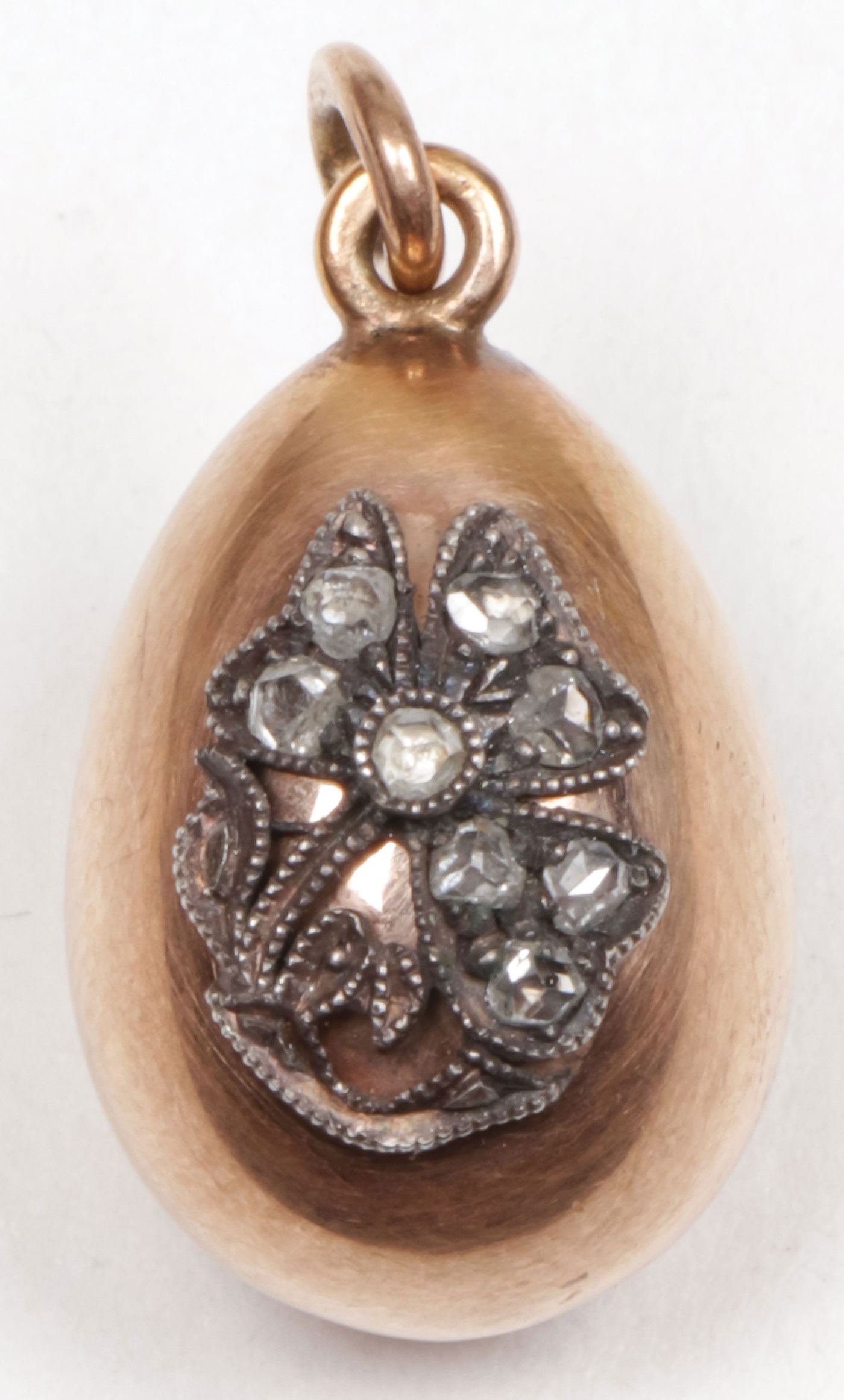 FABERGE GOLD PENDANT EGG: FABERGE GOLD PENDANT EGG The gold egg with diamond studded floral bouquet. Hallmarked St. Petersburg, 56 gold standard, and workmaster's initial AT for Alfred Thielmann. Length .75 inches (2 cm). SHIP