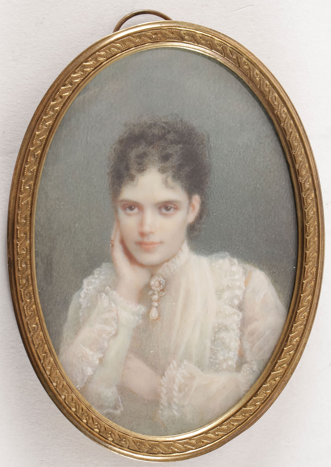 MINIATURE OF TSAREVNA MARIA FEODOROVNA, 19TH C: MINIATURE OF TSAREVNA MARIA FEODOROVNA, 19TH C. Comprising a sensitive half-length portrait in white lace dress with pearl and diamond necklace, in gilt metal glazed oval frame with swivel suspension 