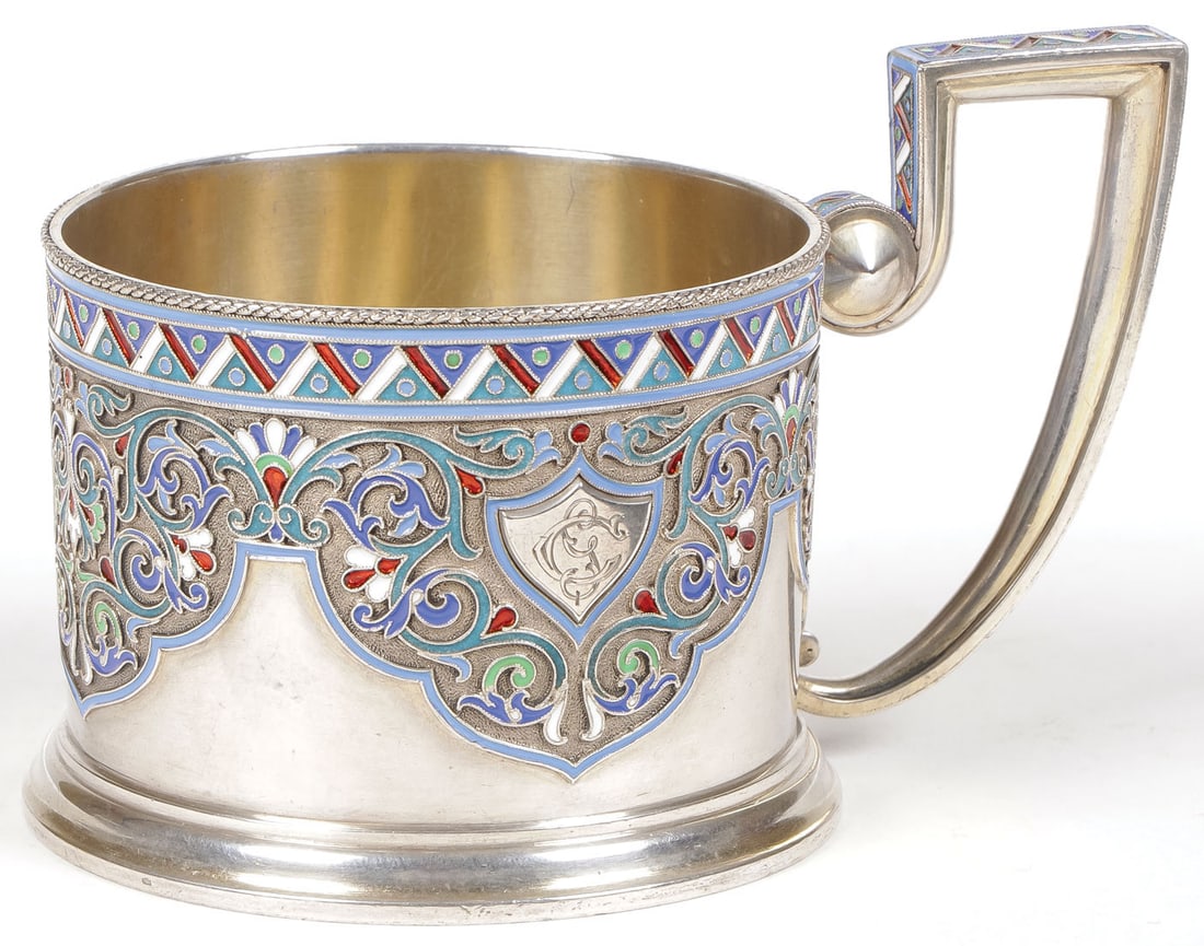 RUSSIAN SILVER & ENAMEL TEA GLASS HOLDER, GRACHEV: RUSSIAN SILVER & ENAMEL TEA GLASS HOLDER, GRACHEV On flared ring foot the sides banded with cloisonné panels and with monogram engraved shield and enameled handle. Hallmarked Moscow, 1896-1908, Cyril