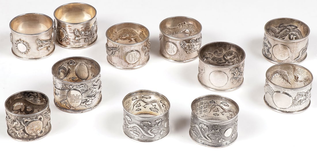 ASIAN SILVER NAPKIN RINGS: ASIAN SILVER NAPKIN RINGS Comprising four matching pairs and three singles, each with dragon motif, greatest measurement 2 inches (5.1 cm), total weight 298 grams. SHIPPING NOTICE:Jackson's is your