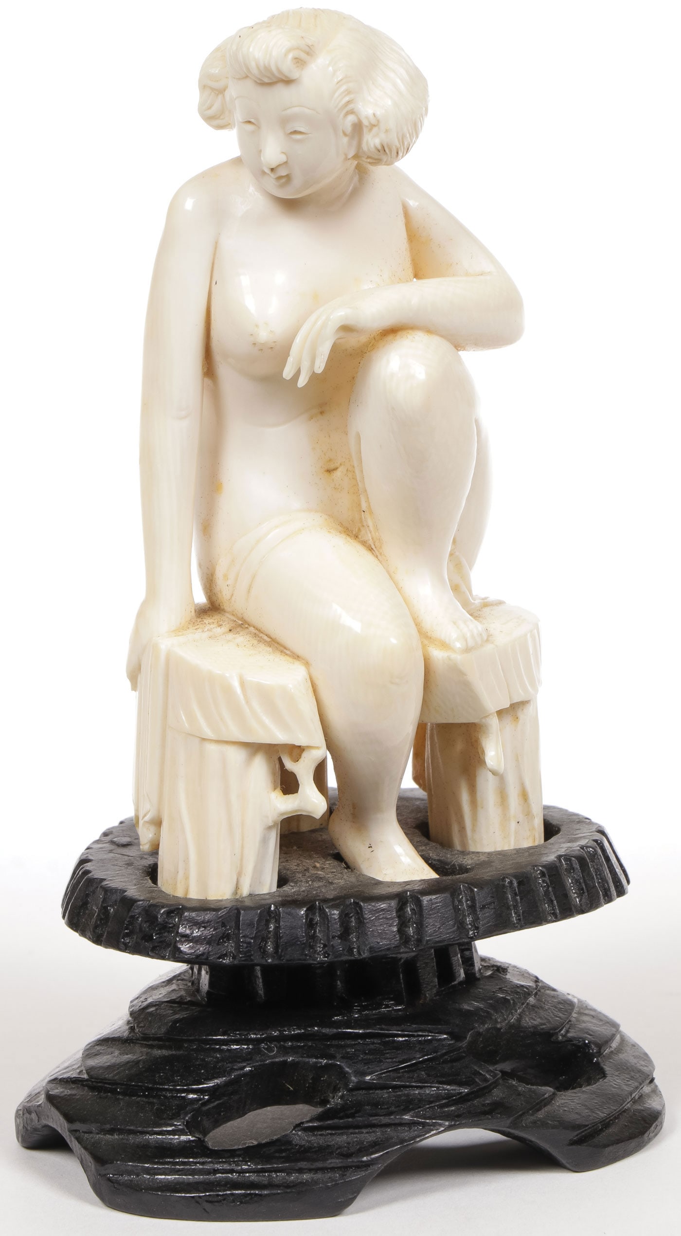 JAPANESE CARVED NUDE OKIMONO C 1920: JAPANESE CARVED NUDE OKIMONO C 1920 Carved in full round as a seated nude woman on a wooden bench and resting on a conforming wood stand. The figure 4 inches (10 cm). NO INTERNATIONAL SHIPPING AND SHI