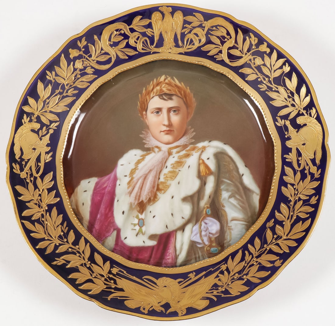 A DRESDEN CABINET PLATE OF NAPOLEON, C 1900: A DRESDEN CABINET PLATE OF NAPOLEON, C 1900 With scalloped rim with cobalt borders with raised gilt decoration of laurels, military trophies and at top the Imperial Eagle. The cavetto with a fine hand
