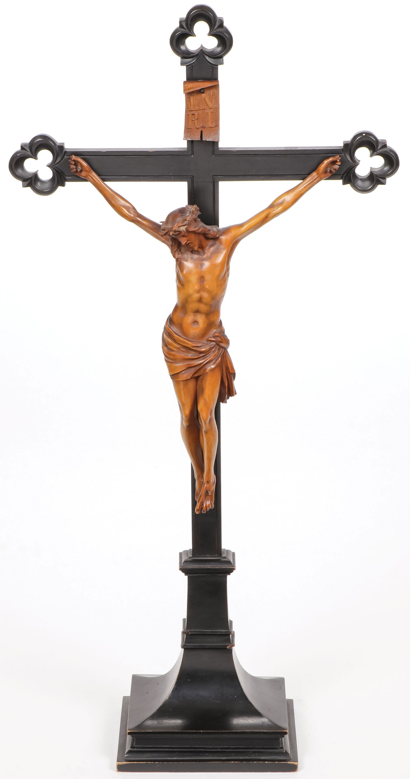 FINE GERMAN CARVED CRUCIFIX, 19TH C: FINE GERMAN CARVED CRUCIFIX, 19TH C Comprising an ebonized wood base and cross, the terminals in pierce trefoil lobes, set with a finely carved fruitwood Corpus Christi of good anatomy and proportions
