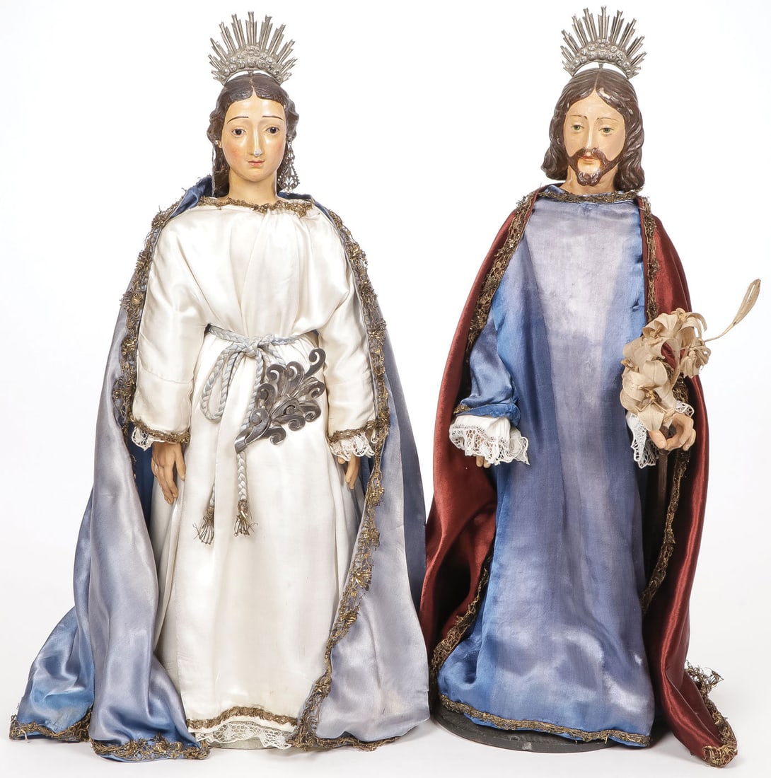 SPANISH CARVED & SILVER SANTOS: SPANISH CARVED & SILVER SANTOS Comprising a matching pair of carved and polychrome wood figures depicting Saint Joseph and the Virgin Mary, each with silver haloes, and the virgin with silver belt ele