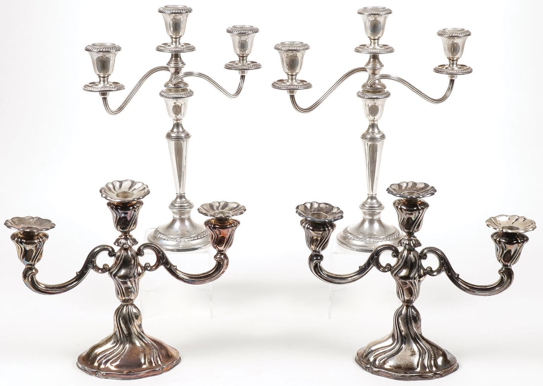 PAIR OF SILVER CANDLESTICKS: PAIR OF SILVER CANDLESTICKS Comprising a pair of three-light candlesticks, one stamped 835 (unweighted), the other taller pair by Gorham with weighted base, marked sterling, height 13.5 inches. SHIPPI
