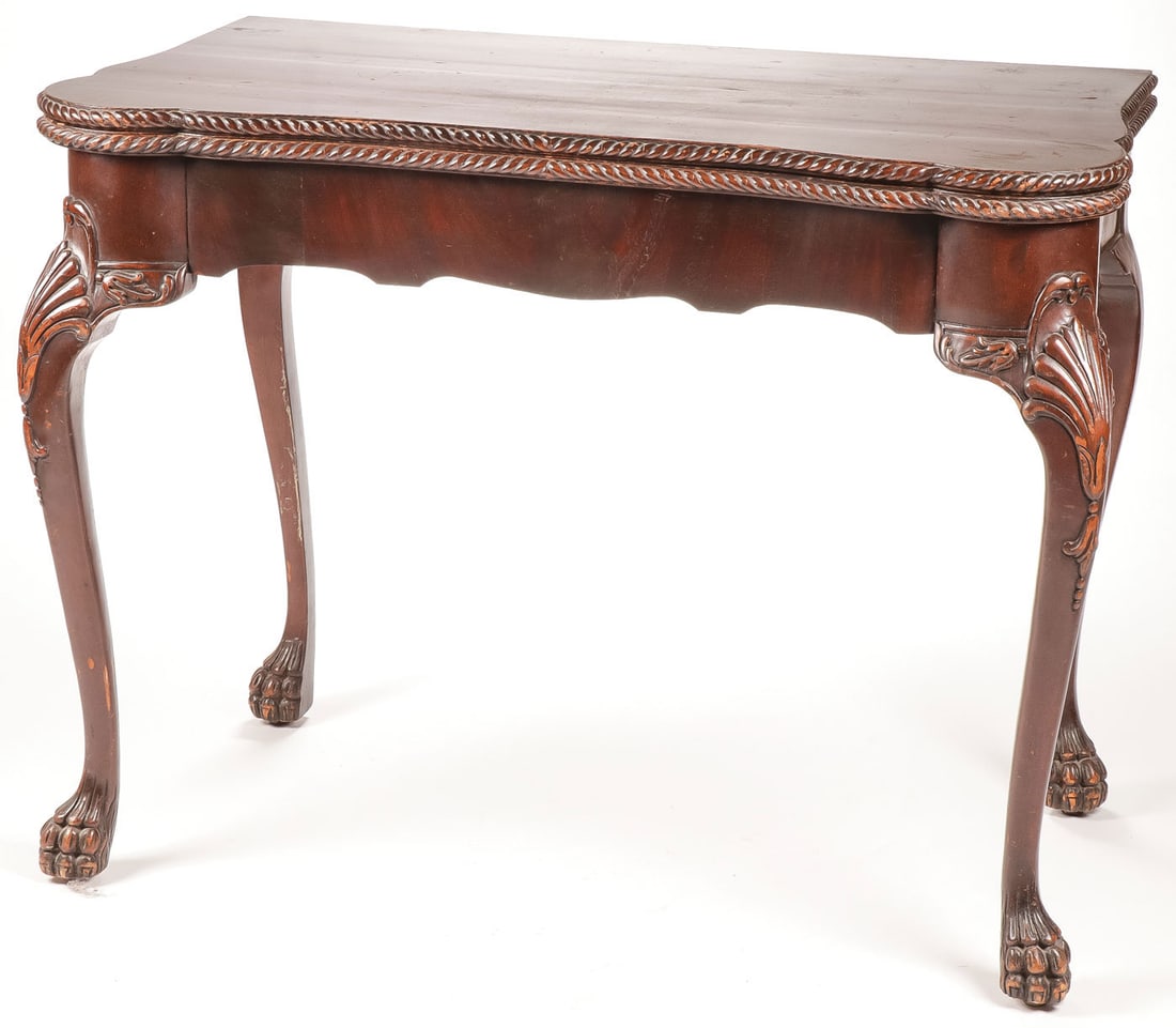 CARVED CHIPPENDALE STYLE GAME TABLE 19th C: CARVED CHIPPENDALE STYLE GAME TABLE 19th C Heavily carved cabriole legs terminating in paw feet, serpentine skirt, gadrooned edge with folding top, height 30 inches, depth 22 inches, width 40.5 inches