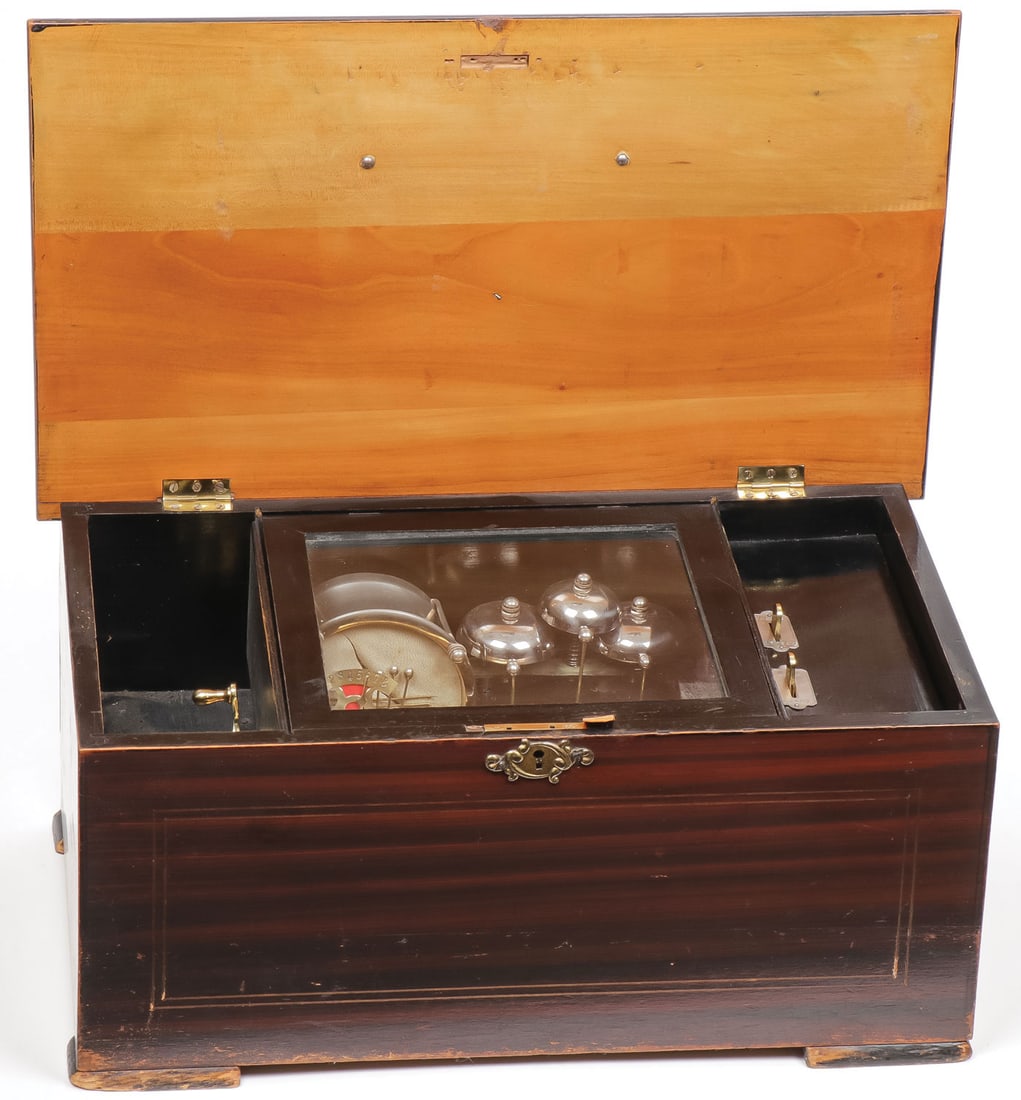 A GOOD CYLINDER MUSIC BOX, 19TH C: A GOOD CYLINDER MUSIC BOX, 19TH C. Grain painted case on bracket feet. The hinged lid opening to reveal a 6.25 inch cylinder, 42 tooth comb, three bells and snare drum. Takes a wind and plays. Height