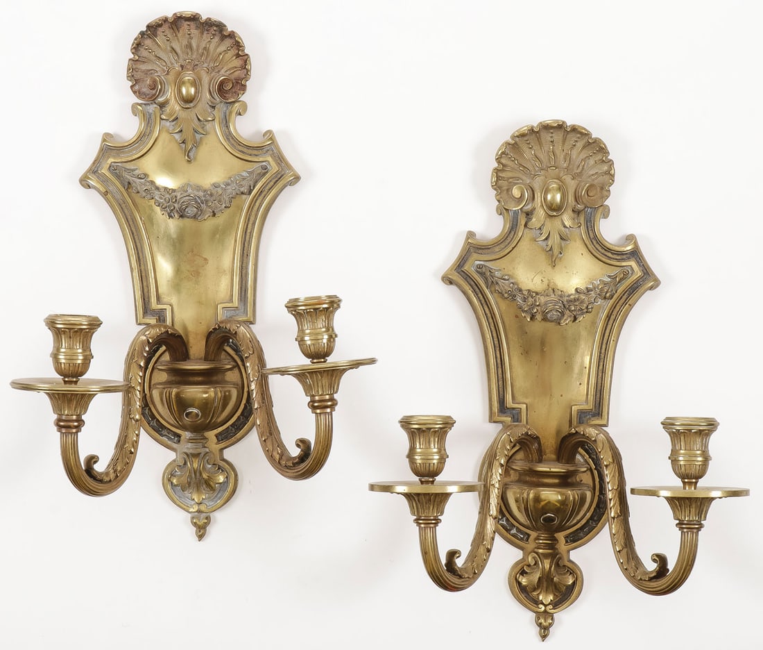 PR FRENCH GILT BRONZE WALL SCONCES, 19th C: PR FRENCH GILT BRONZE WALL SCONCES, 19th C Comprising a matching pair of double-light wall sconces with floral swag and clam shell finial. Height 15.25 inches (38.5 cm). SHIPPING NOTICE: Jackson's is