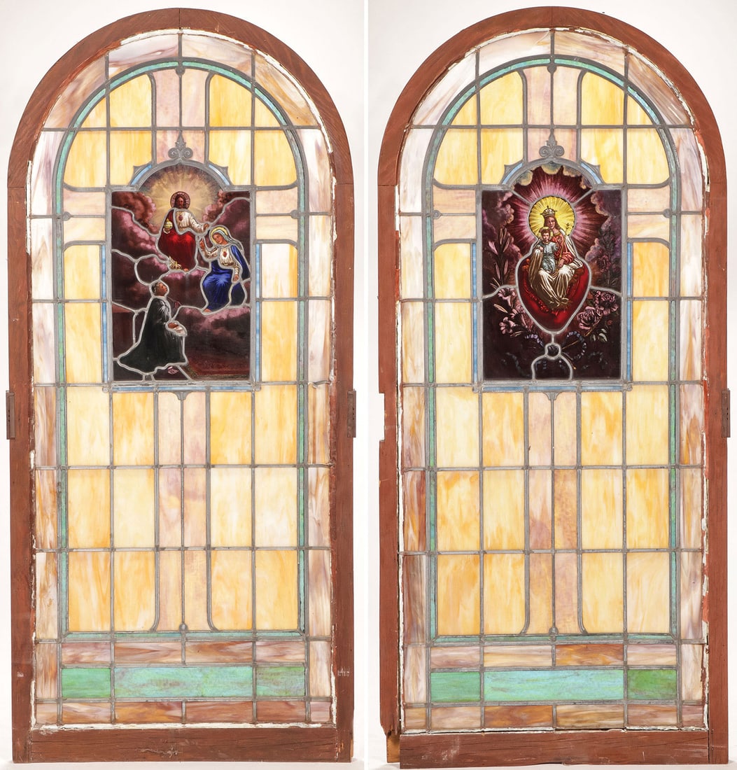 PAIR OF LEADED STAINED GLASS WINDOWS: PAIR OF LEADED STAINED GLASS WINDOWS Each with arched wood frame and leaded slag glass panels surrounding a stained glass image, one depicting Christ enthroned in the heavens with the Virgin Mary and 