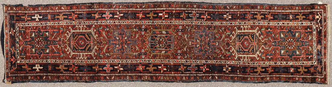 PERSIAN KARADJA RUG C 1930: PERSIAN KARADJA RUG C 1930 The long runner having a rust ground with row of seven central medallions in repeating patters with navy main border, 34 inches x 125 inches SHIPPING NOTICE: Jackson's is y