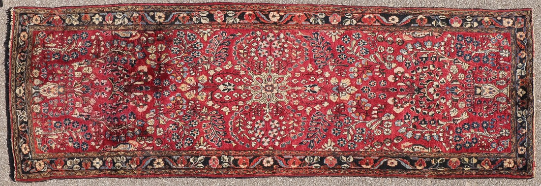 PERSIAN SAROUK CIRCA 1930: PERSIAN SAROUK CIRCA 1930 With overall floral design on red ground with navy border, 28 inches x 80 inches. SHIPPING NOTICE: Jackson's is your sole and only source for one stop packing and shipping.