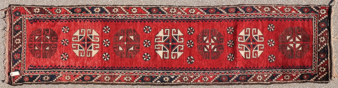 NICE ORIENTAL RUG RUNNER: NICE ORIENTAL RUG RUNNER With repeating ivory and red medallions on red ground, 103 inches x 28 inches. SHIPPING NOTICE: Jackson's is your sole and only source for one stop packing and shipping. Wit