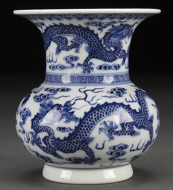 A CHINESE BLUE AND WHITE PORCELAIN DRAGONS VASE: A CHINESE BLUE AND WHITE PORCELAIN DRAGONS VASE, 19TH/20TH CENTURY. Decorated with four dragons, finely painted with scrolling cloud forms. Blue Qianlong archaic seal mark on base. Height 4.5 inches (