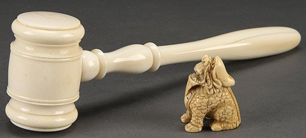 A EUROPEAN IVORY GAVEL AND JAPANESE IVORY NETSUKE: A EUROPEAN IVORY GAVEL AND JAPANESE IVORY NETSUKE, LATE 19TH/20TH CENTURY. The gavel with turned head and handle, the netsuke carved as a mythical beast. Length 8.5 inches (21 cm), height 1.5 inches (