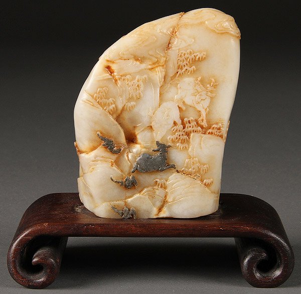 A VERY FINE CHINESE CARVED BOULDER: A VERY FINE CHINESE CARVED SOAPSTONE BOULDER, PROBABLY QING DYNASTY. Finely carved depicting a mountainous scene with two deer, pine trees and bats. Height 4 inches (10 cm), excluding carved wood base