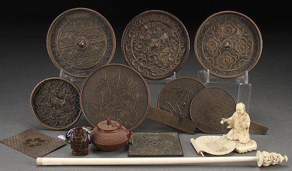 A JAPANESE BRONZE MIRROR AND CARVED IVORY GROUP: A JAPANESE BRONZE MIRROR AND CARVED IVORY GROUP, 19TH/20TH CENTURY. Comprising nine various bronze mirrors with embossed decoration, the largest 4.5 inches (11.5 cm) diameter; a carved ivory okimono o