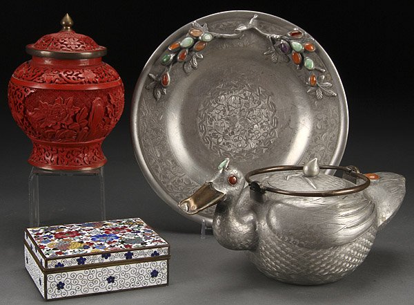 CHINESE CINNABAR CLOISONNE DECORATIVE ARTS GROUP: A CHINESE CINNABAR CLOISONNÉ AND PEWTER DECORATIVE ARTS GROUP, EARLY 20TH CENTURY. Comprising a pewter duck form teapot and tray with hardstone ornaments, a lidded carved cinnabar jar and a floral de