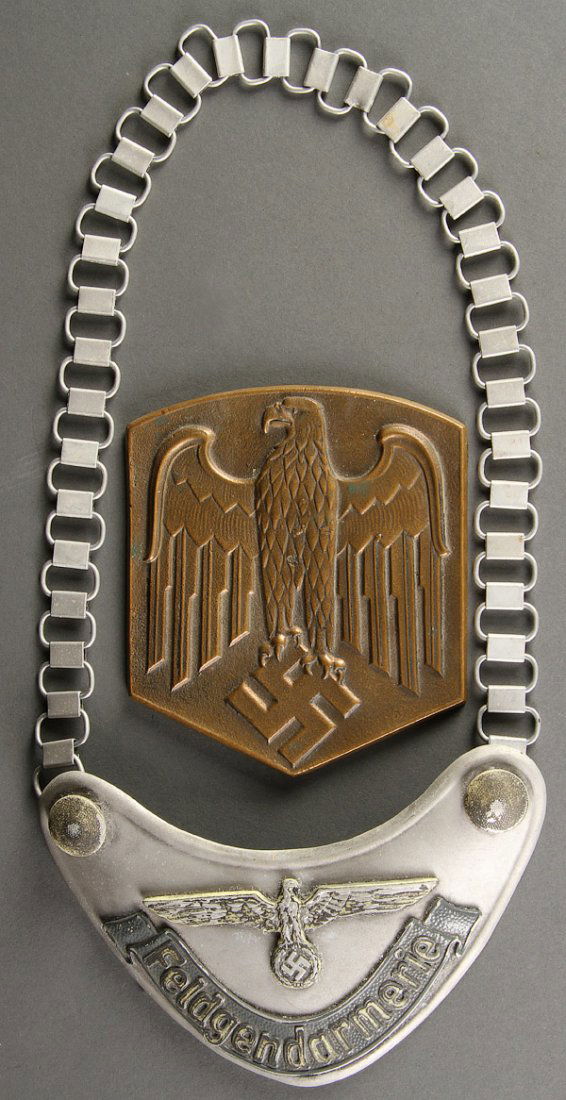 GERMAN WWII STYLE MEMORABILIA: GERMAN WWII STYLE MEMORABILIA. Comprising a Feldgendarmerie Gorget (post war), a bronze relief plaque with National Eagle symbol and a post war German Luftwaffe (Air Force) officers peak cap.