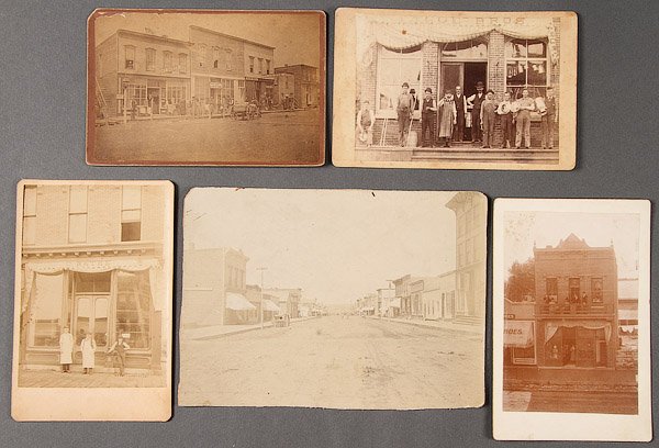 RARE VINTAGE PHOTOGRAPHS EARLY MAIN STREET 19TH C.: TEN EARLY COMMERCIAL AND RETAIL STOREFRONT PHOTOGRAPHS, LATE 19TH/EARLY 20TH CENTURY. Including a view of Chamberlain, South Dakota; First National Bank; J.U. Potts Jewelry Store; a view of Kimball,