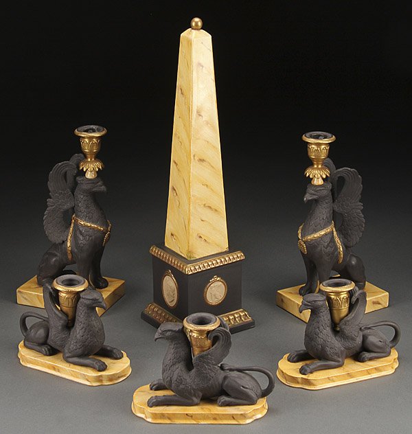 CANDLESTICK & ORNAMENTS, MOTTAHEDEH PORCELAIN: A MOTTAHEDEH ITALIAN PORCELAIN EMPIRE REVIVAL FIGURAL CANDLESTICK AND ORNAMENT GROUP, LAST HALF 20TH CENTURY. Comprising a model of the Luxor Column, two standing winged griffin candlesticks, and thre