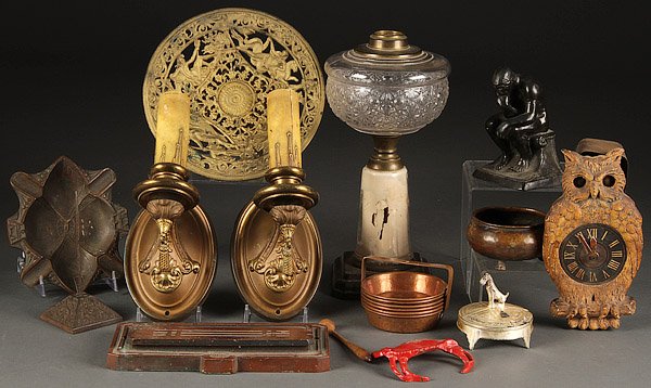 A VINTAGE METALWORKS AND DECORATIVE ARTS GROUP: A VINTAGE METALWORKS AND DECORATIVE ARTS GROUP, 19TH/20TH CENTURY. Comprising an iron and pressed glass oil lamp, a figural owl clock, Wonder Foundry bronze ashtray, an iron art gilt tazza, Arts and