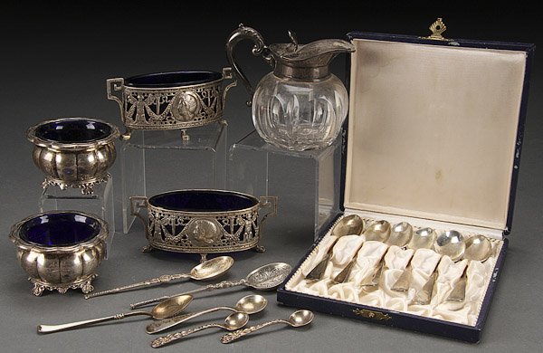 A STERLING AND SILVER TABLEWARES GROUP: A STERLING AND SILVER TABLEWARES GROUP, EARLY 20TH CENTURY. Comprising two Birks salts with cobalt blue inserts, two Continental salts with cobalt inserts, cut glass cream jug with sterling lid and ha