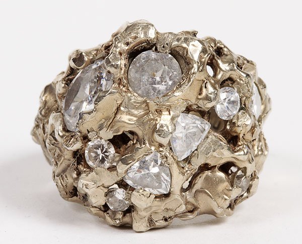 A WHITE GOLD DIAMOND AND SAPPHIRE MENS RING: A CONTEMPORARY WHITE GOLD AND SAPPHIRE MENS RING. Stamped 585, of nugget form, containing three approximately .20 carat diamonds and larger white sapphire or zircon stones. Weight 24 grams.