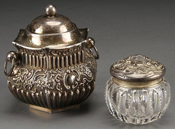 ENGLISH SILVER TEA BOX & CUT GLASS POMMADE: AN ENGLISH SILVER CHINOISERIE TEA BOX AND SILVER MOUNTED CUT GLASS POMMADE, CIRCA 1900. The tea box with mark of William J. Holmes, Birmingham 1898, and the cut glass jar with embossed lid of an Art N