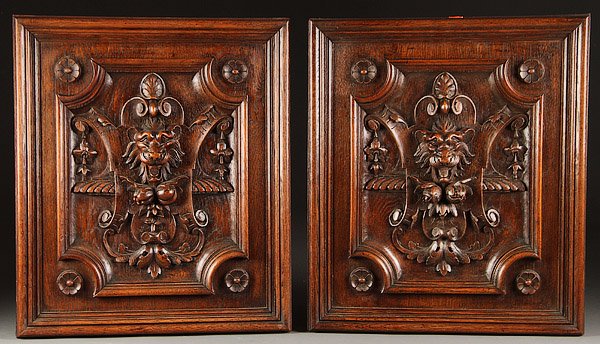 SWISS CARVED BLACK FOREST OAK FURNITURE PANELS: A GOOD PAIR OF SWISS CARVED BLACK FOREST OAK FURNITURE PANELS, CIRCA 1900. Each well carved in deep relief with lion head masks, scrolled cartouches and floral pendants, later mounted as wall plaques,