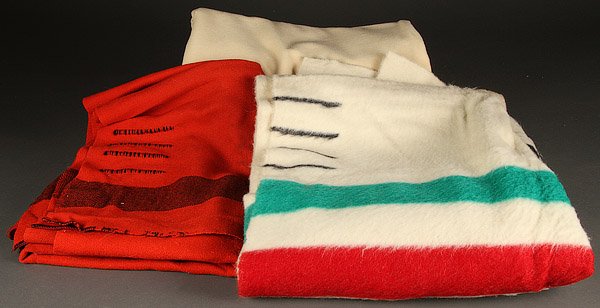A HUDSON BAY FOUR POINT WOOL BLANKET: A HUDSON BAY FOUR POINT WOOL BLANKET. With Hudson Bay label, together with a red wool point blanket and a navy wool blanket.