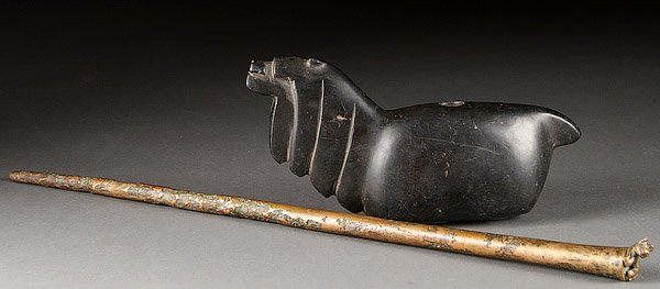 PRE COLUMBIAN STAFF & CARVED STONE EFFIGY: AN INCAN CHAMPI BRONZE FIGURAL STAFF AND ALPACA EFFIGY VESSEL, PROBABLY PRE-COLUMBIAN CUSCO. Of cylindrical tapered form surmounted by a figural puma. Displays considerable oxidation and pitting, toge